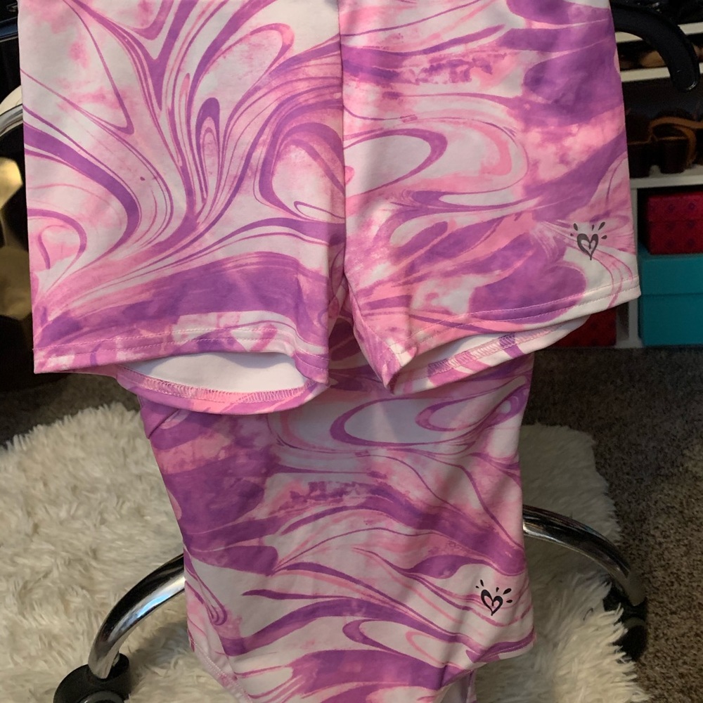 Two Justice gymnastic leotards with matching shorts.
